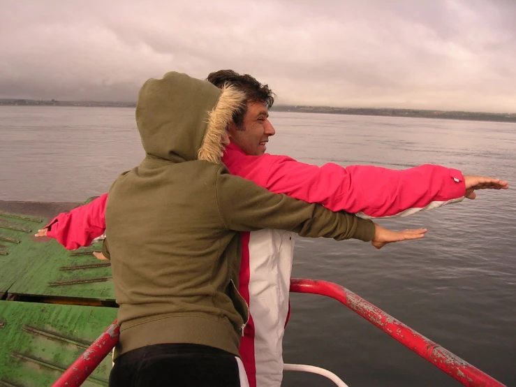 a man on a boat looking at soing in the water