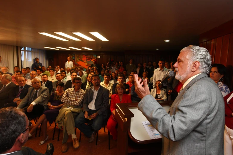 a man is giving a speech to a crowd