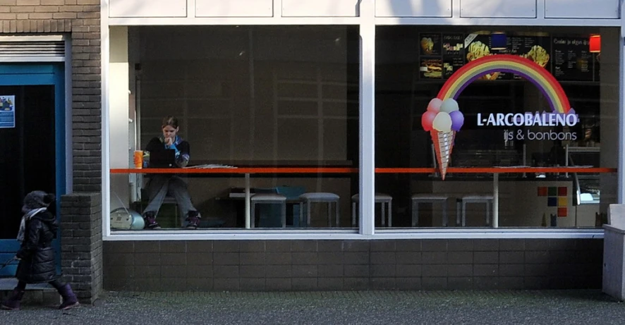 a man walking in front of a building with balloon decoration