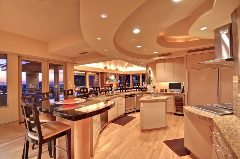 an open concept kitchen with island bar area and panoramic view