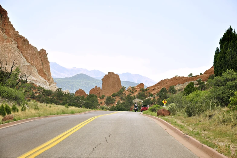 a view down a small country road near mountains