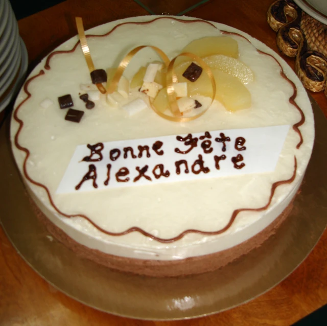 a cake with white frosting and chocolate decorations on it