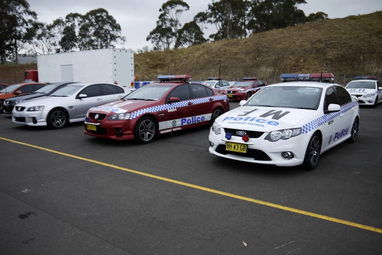 four different police cars in a parking lot