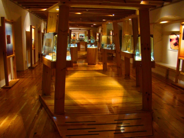 a room filled with wooden poles and art on display