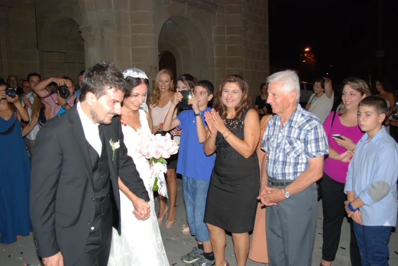 an old couple is greeting a group of people