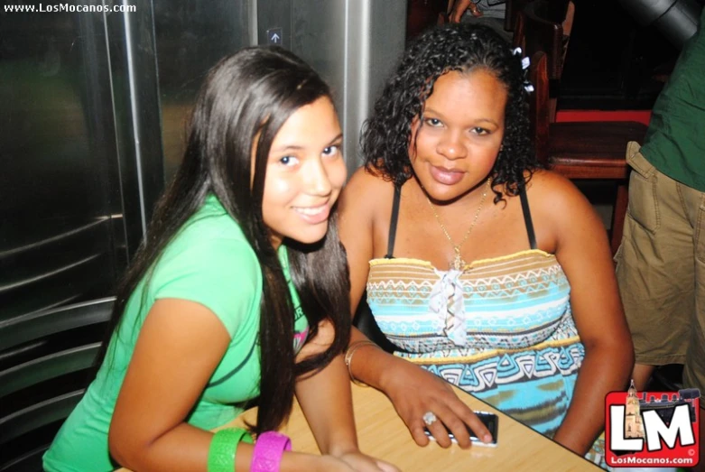 two women that are sitting down at a table