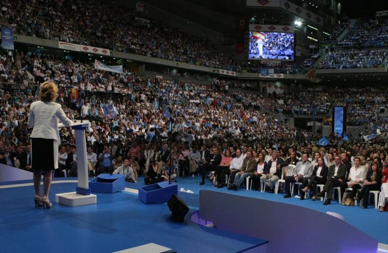 politician speaking in front of an audience on a stage