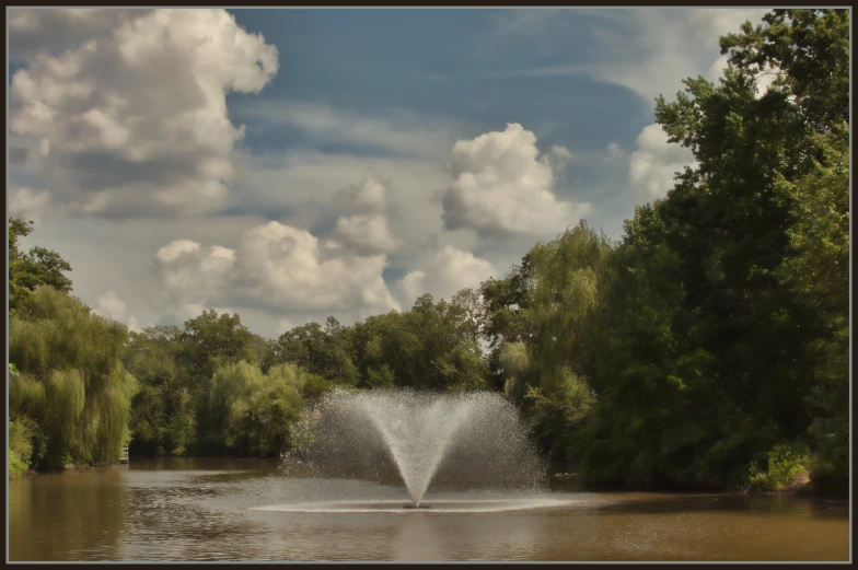 a large fountain spewing water out onto a lake