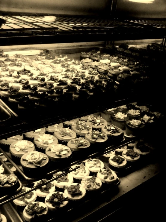 a bunch of cupcakes are lined up on the racks