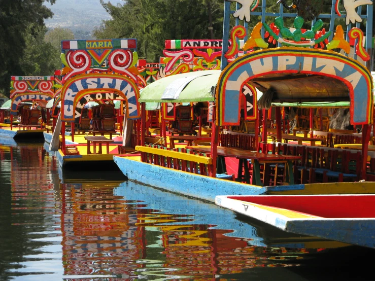 boats floating on a lake next to a forest