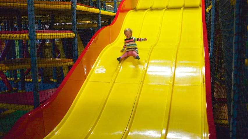 a small child is riding on an inflatable slide