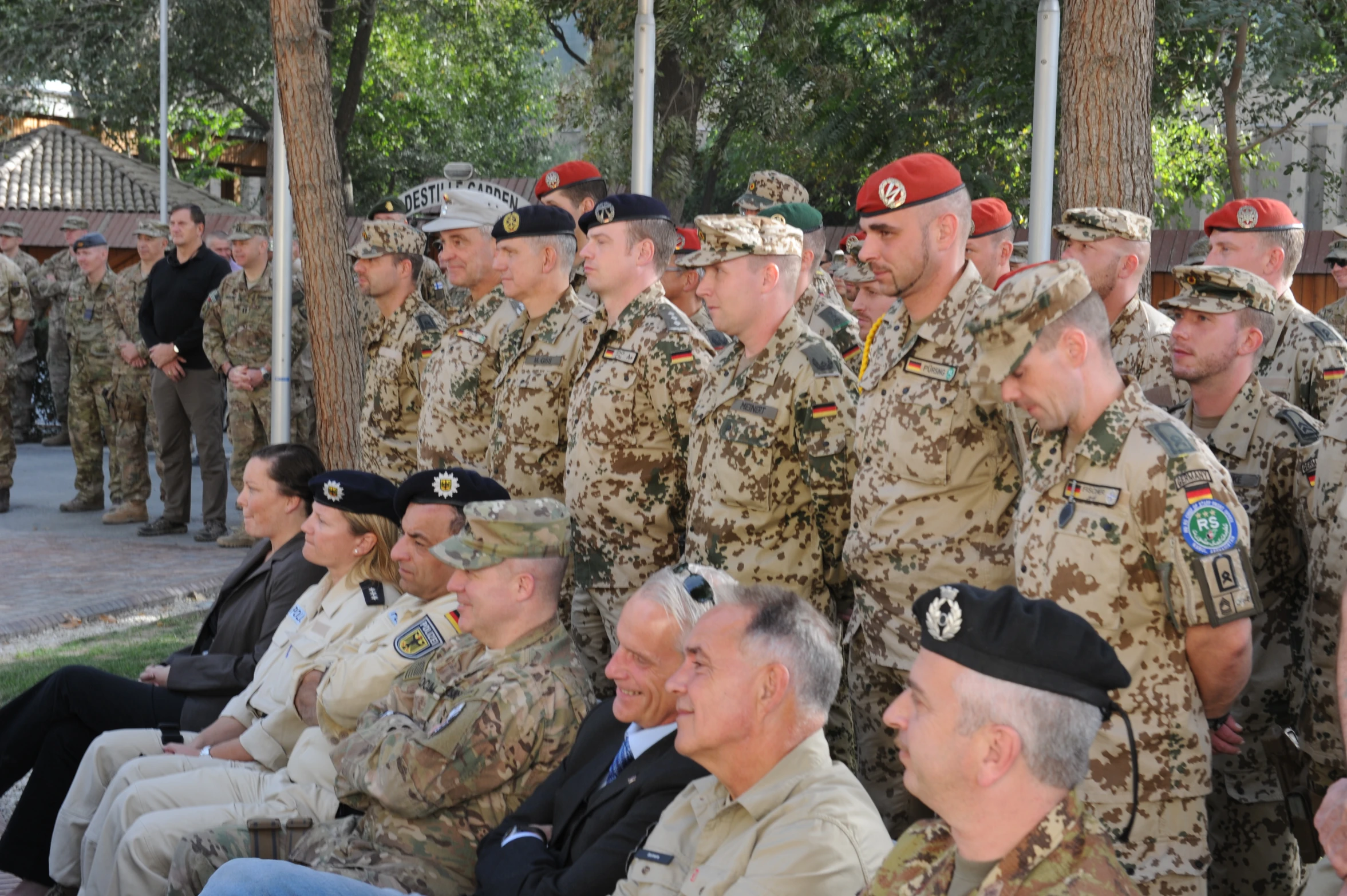 a group of soldiers sit on chairs while talking