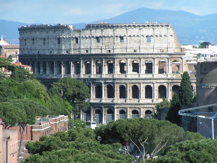 a large building has many windows near trees