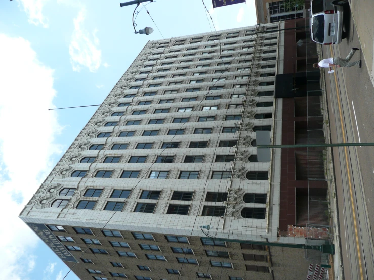 an old building on a city street with a man walking past