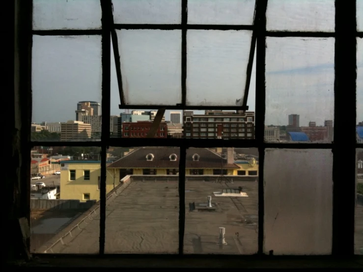 a large window view from an abandoned factory