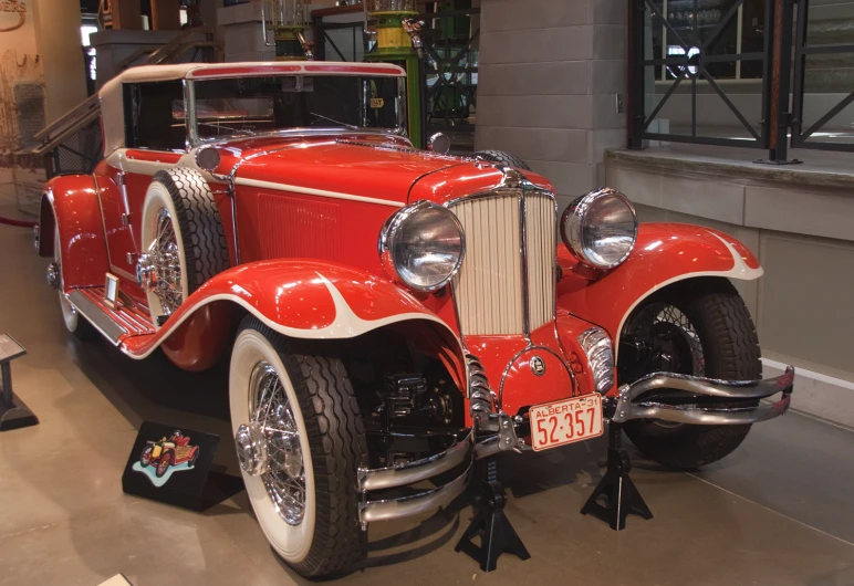 an antique car is on display at the museum
