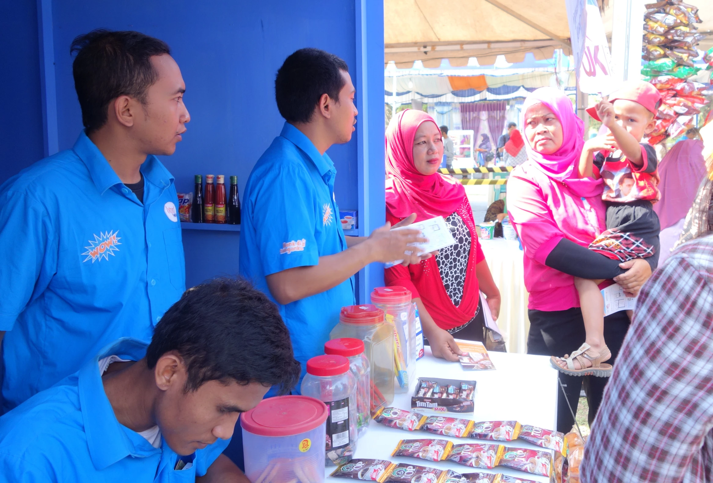 a group of people stand at a table with drinks