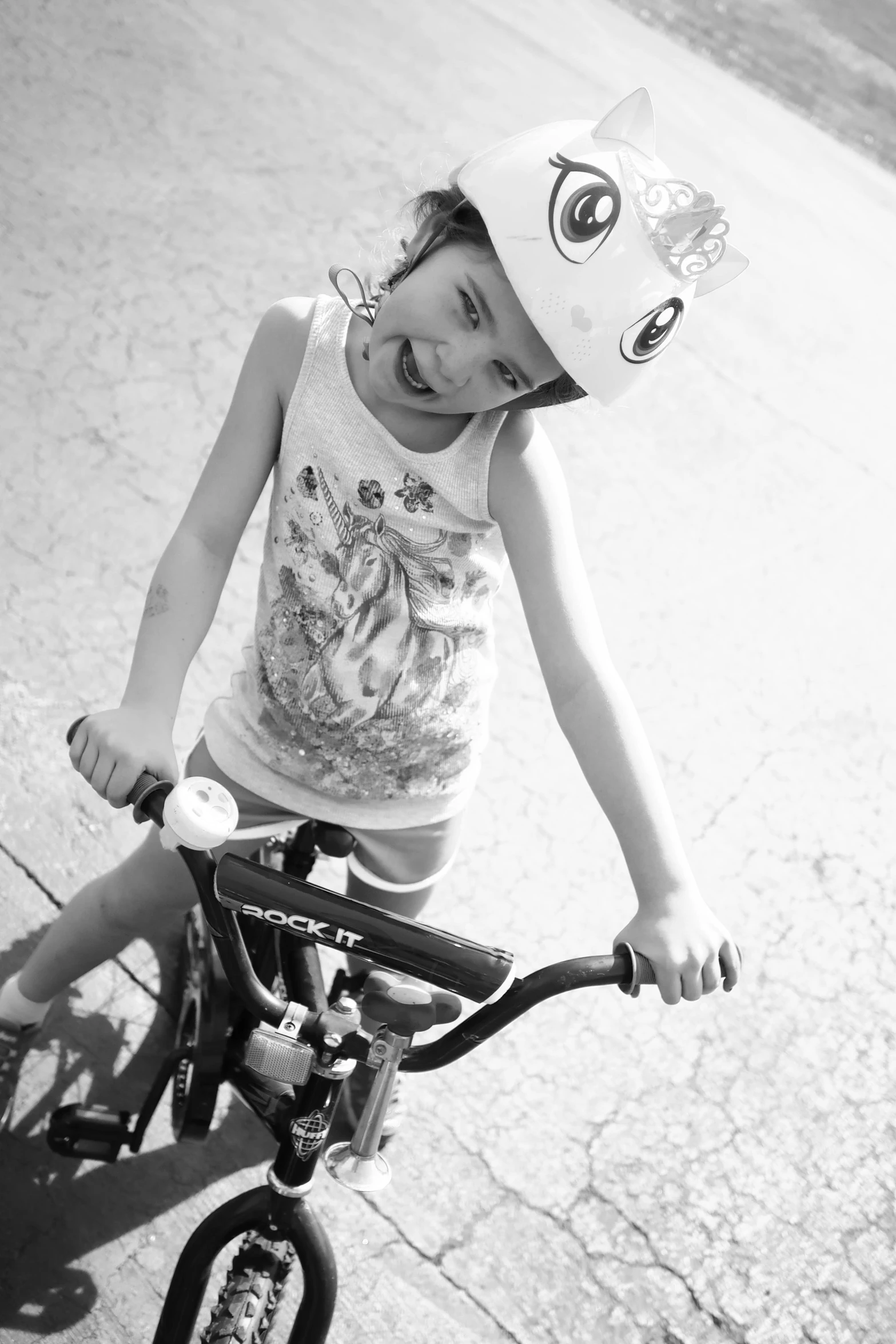 girl riding a bike wearing a helmet smiling