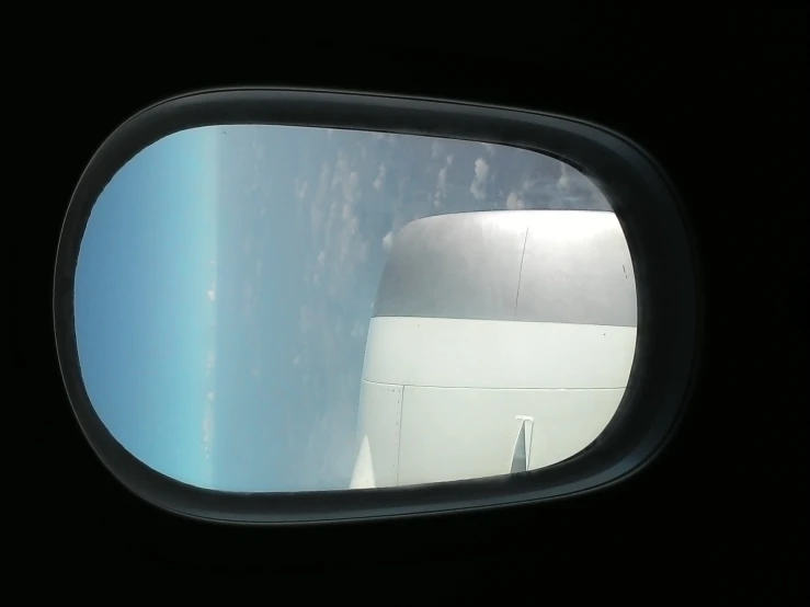 the wing of an airplane and a cloud below