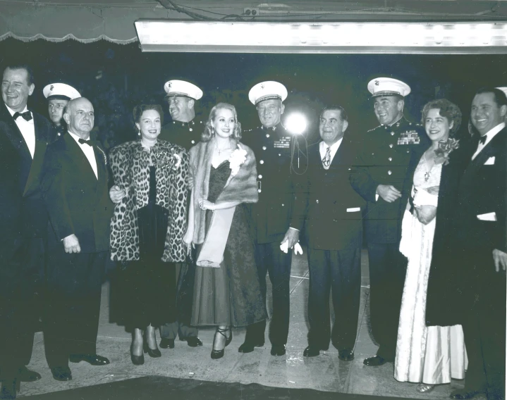a group of people in navy attire standing together