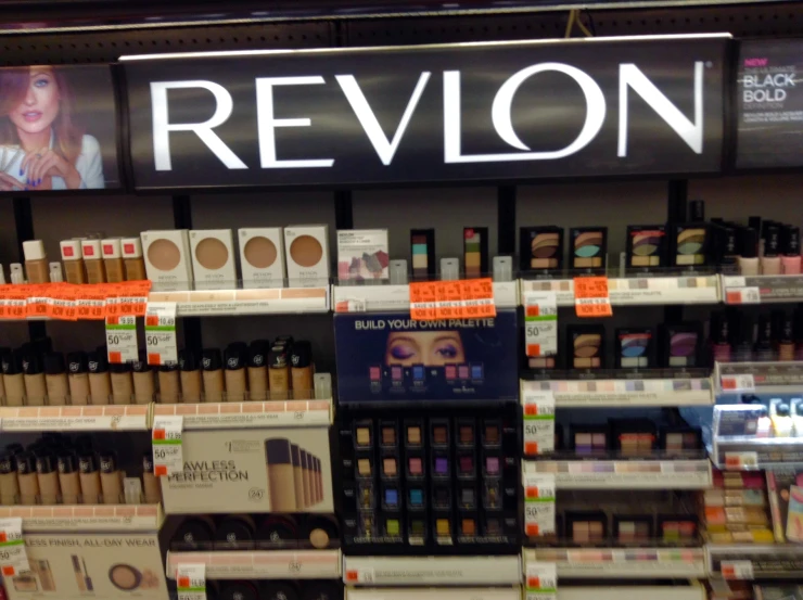 there are bottles of makeup and cosmetics on display in the store