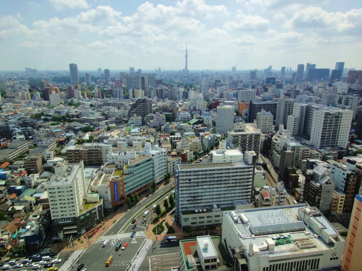 the view of city from above with a tall building in the background