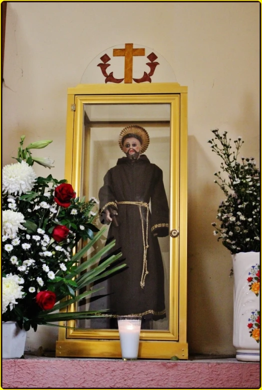 a statue of saint michael standing in a golden frame