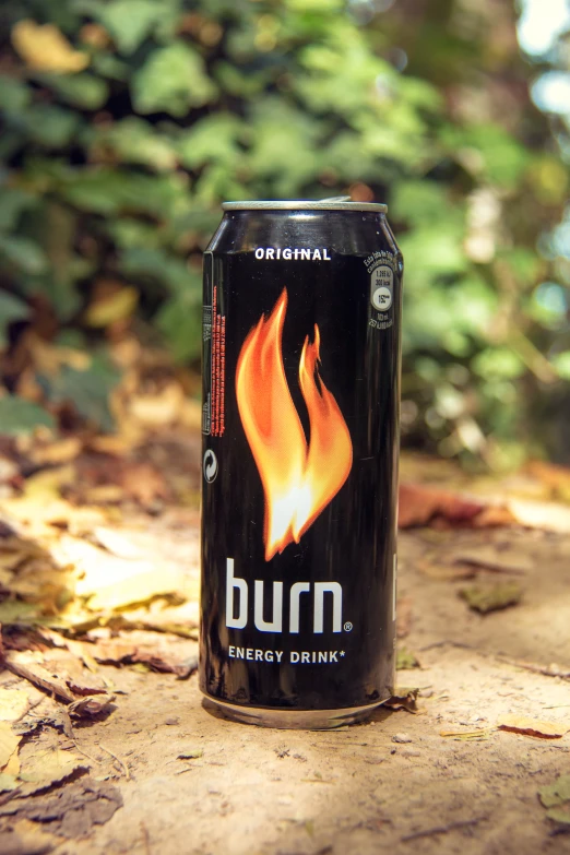 an energy drink can sitting on the ground