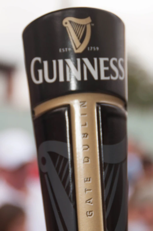 the guinness logo on a bottle is gold