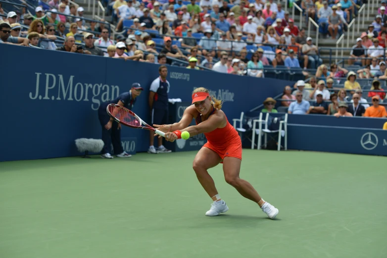 a tennis player is swinging the racket at a ball