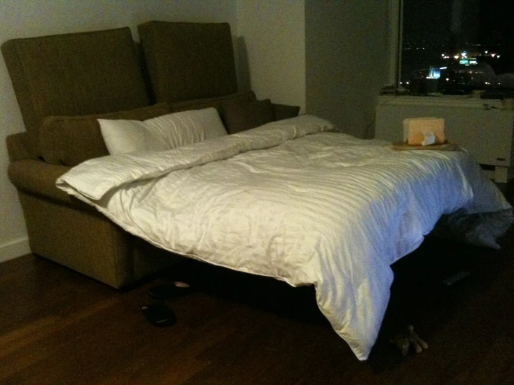 a bed in a room with a sofa on it