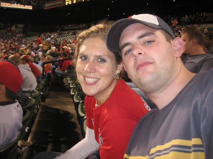 two people taking a picture in a stadium