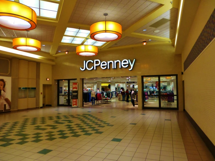 a large, empty mall with lots of customers and lights