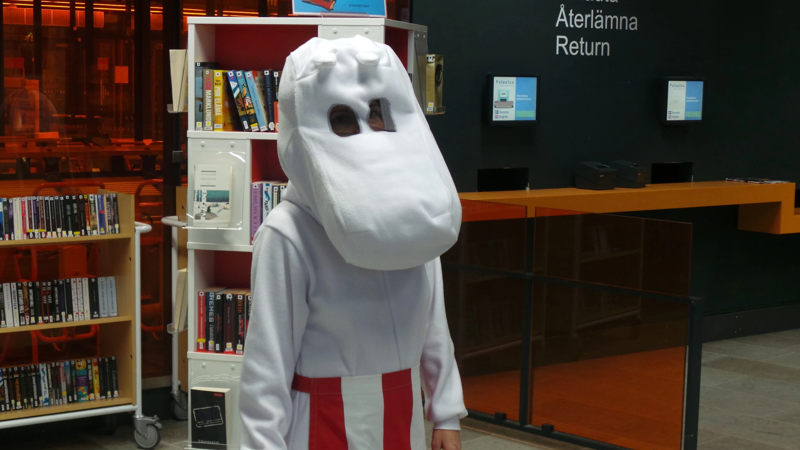 a man in a white ghost costume posing for the camera