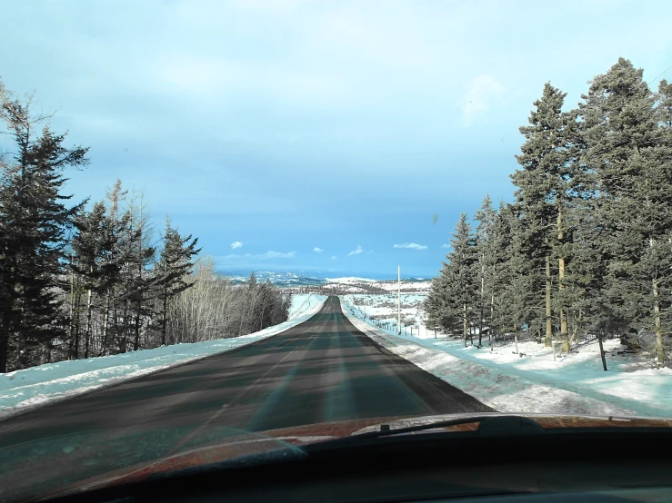 a view from inside a car of a snow covered street