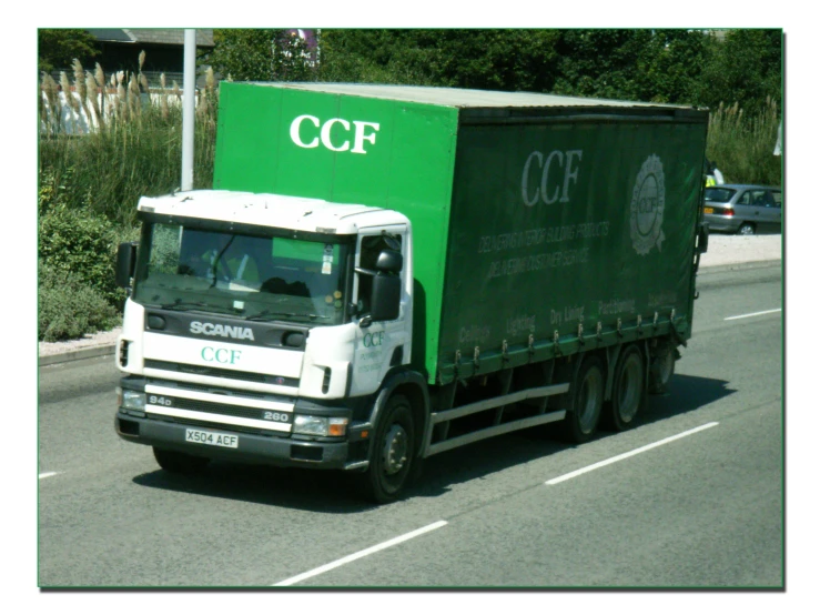a semi truck with a green side trailer