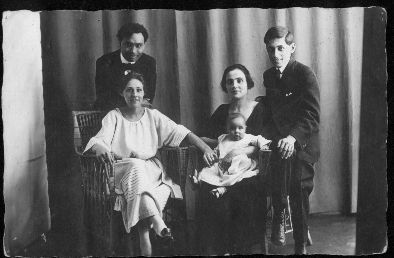 a group of men and women sitting in chairs next to each other