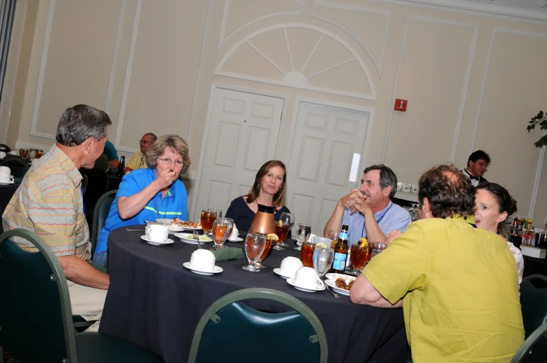 people in a dining room eat food and drink