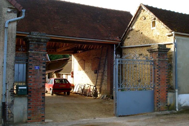 an old barn with a car in it