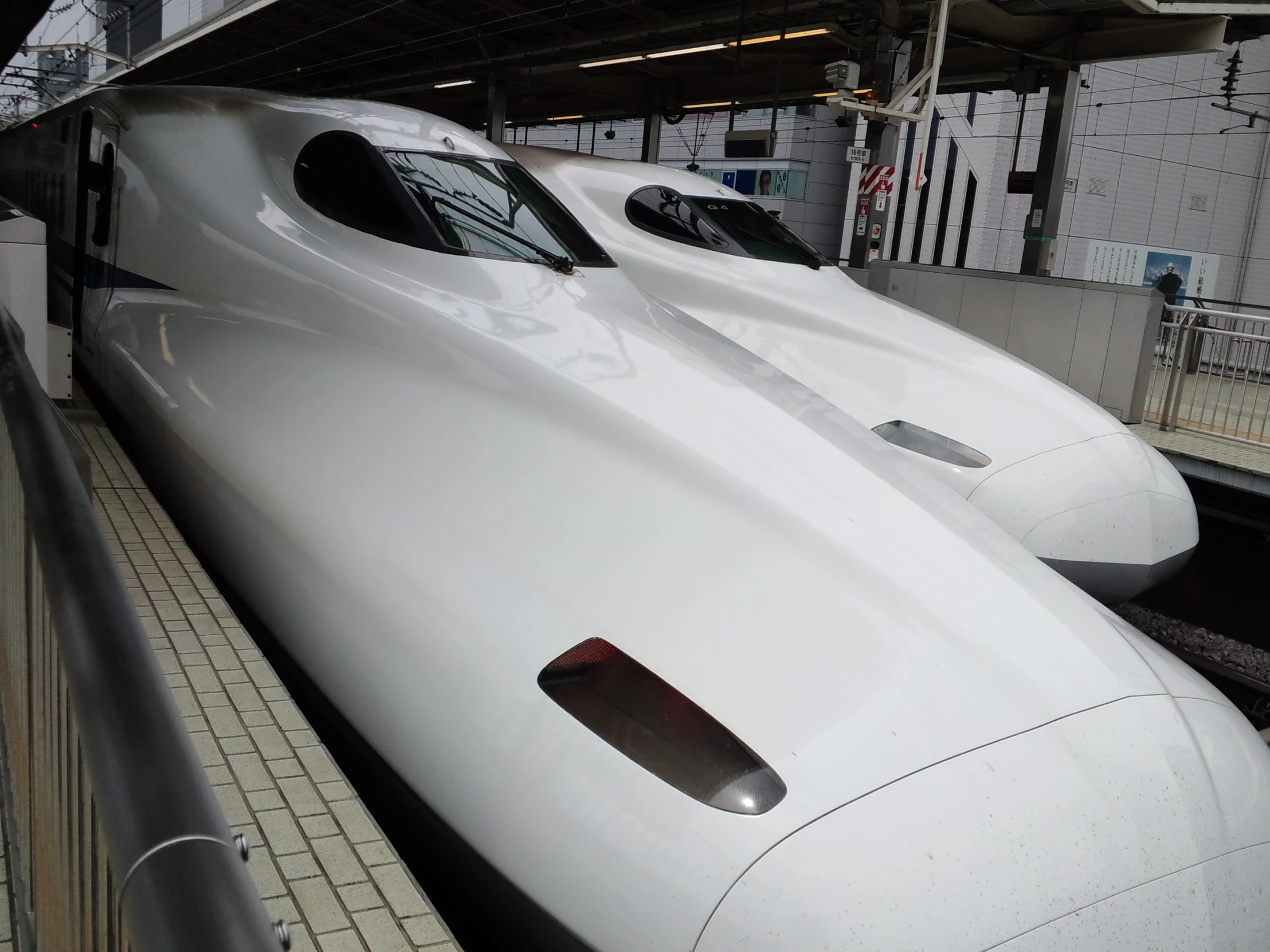 two very shiny trains parked next to each other