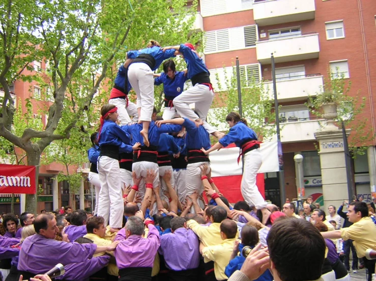 several people in purple and yellow surrounding an audience