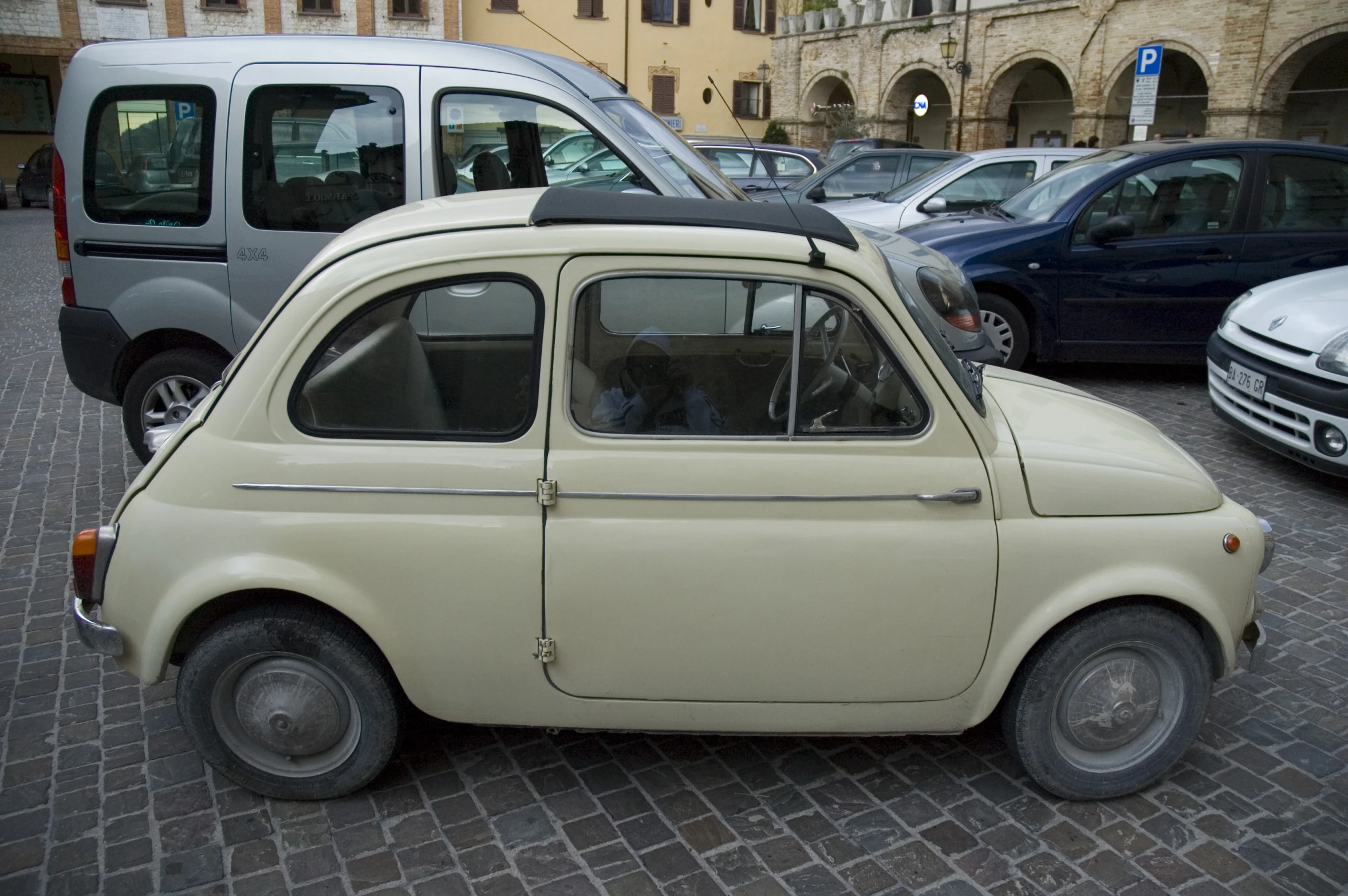 there is an old car parked on the street