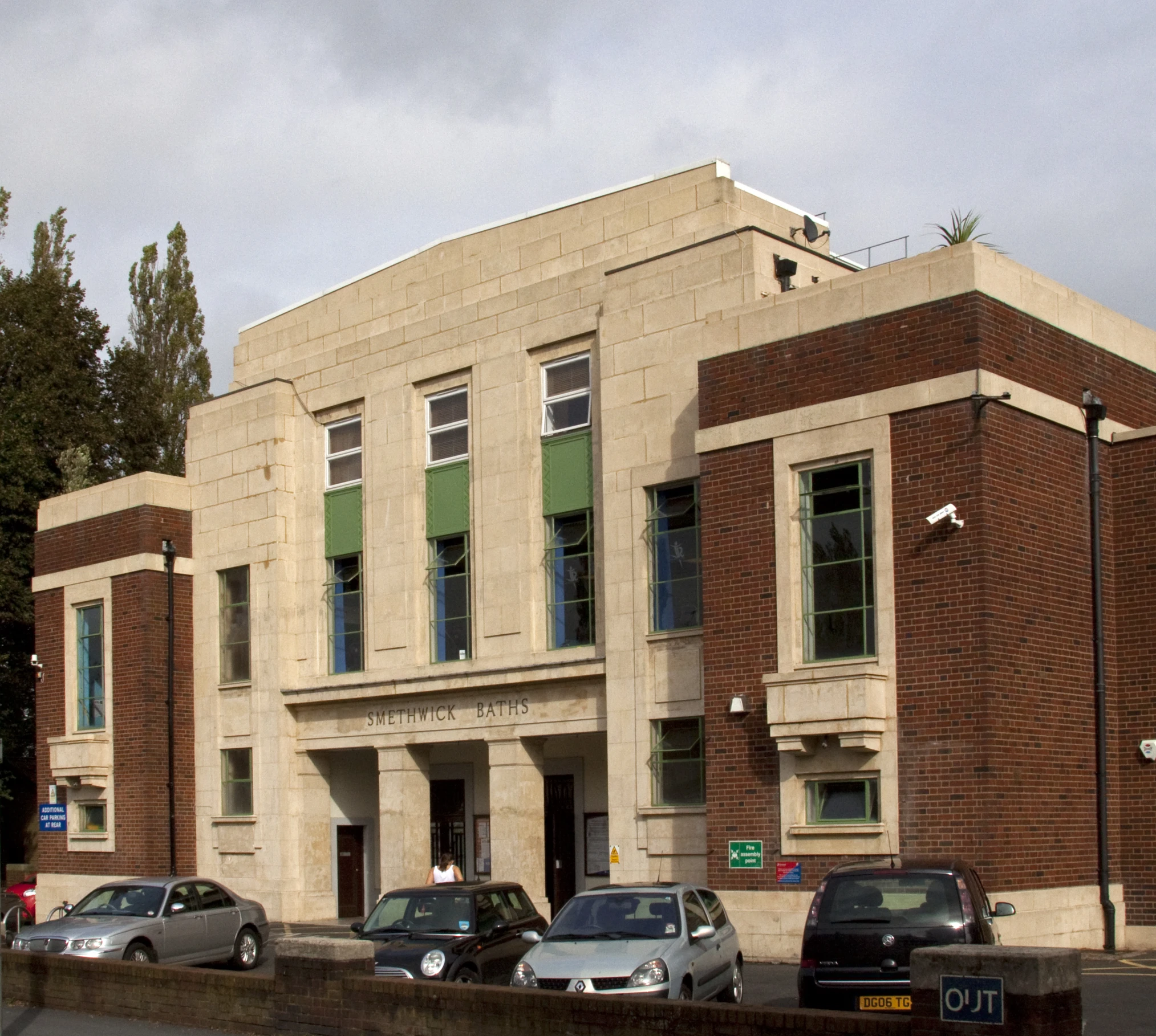 a very old building with cars parked in front