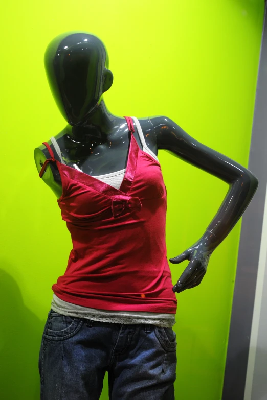 a female mannequin with an red top and blue jeans