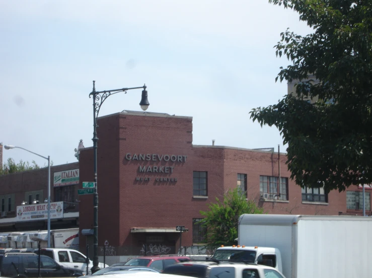 the large warehouse building has a sign and an antenna