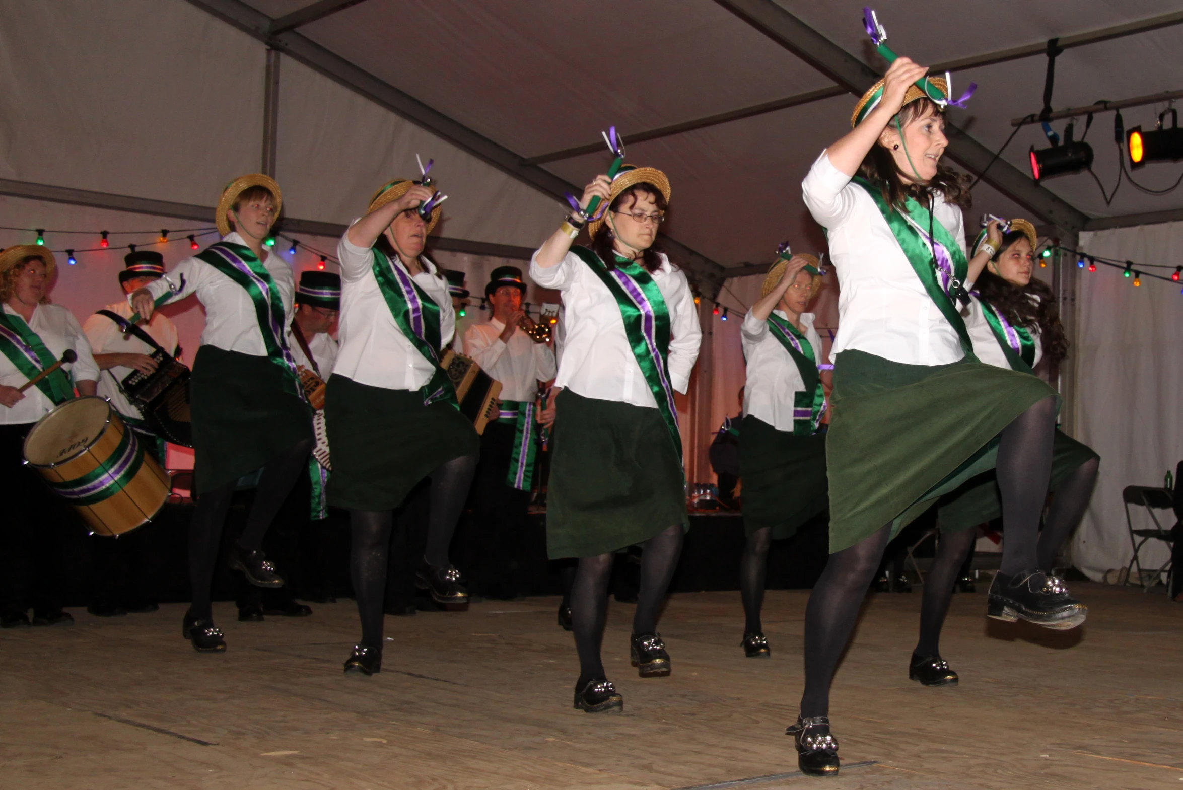 several young people dance on the floor with musical instruments