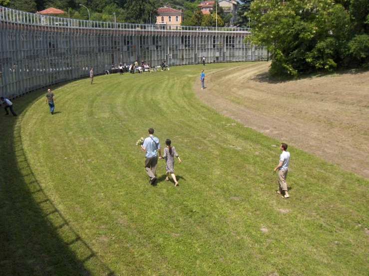 a group of people are playing ball in the yard