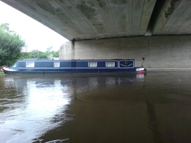 a large boat is sitting under an overpass