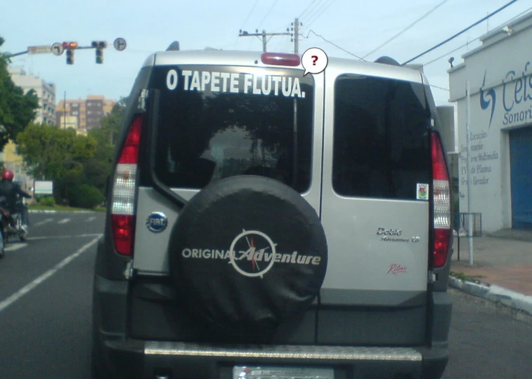 a van parked next to an intersection with another vehicle in the background