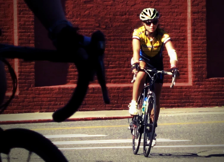 this woman is riding her bike down the street